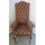 A Georgian Revival highback armchair, upholstered in a claret striped material embroidered with