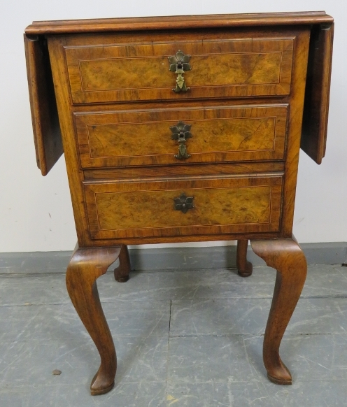 An antique burr walnut side cabinet, crossbanded and strung with boxwood and satinwood, with drop