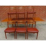 A mid-century teak Danish draw-leaf dining table in the manner of Hans J. Wegner, together with