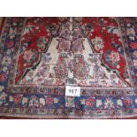 A Mahal rug, red and cream central pattern field on a blue patterned border. 2.05 x 1.30.