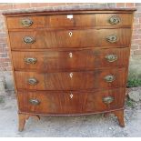 A Regency Period flame bow fronted mahogany chest of four long graduated drawers, featuring beaded