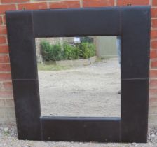 A large contemporary square wall mirror in a black leather surround. Condition report: Some scuffs
