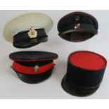 Four vintage military caps including Russian, Austrian, French and British. Three with cap