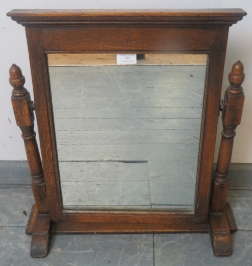 A vintage oak swing vanity mirror in the 18th century taste, with carved cornice and turned and