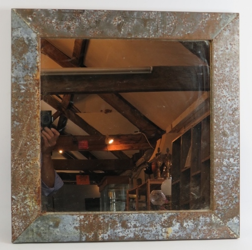 A heavily patinated industrial style wall mirror with galvanised steel frame. 61cm x 61cm. Condition