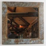 A heavily patinated industrial style wall mirror with galvanised steel frame. 61cm x 61cm. Condition