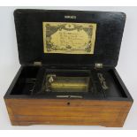 A small antique Swiss music box with lever wind mechanism original label and inlaid case. 35cm x