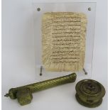 An Indo-Persian brass calligraphers Qalamdan pen box, a brass Eastern inkwell and a framed page of