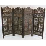 A four panel carved hardwood Indo-Persian screen with intricate grape and vine panels. Height