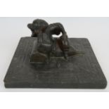 An antique Chinese bluestone carving of a reclining female with bound feet in the centre of a slab