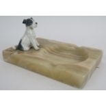 An Art Deco style onyx ashtray with porcelain terrier mount. 15cm x 10cm. Condition report: No