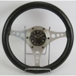 A vintage Jaeger mechanical dashboard clock mounted in a 1960s alloy and stitched leather GT
