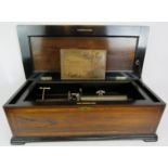 A large impressive 19th century Swiss music box with original play list card guaranteeing 45 minutes