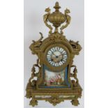 A 19th Century Ormulu striking mantel clock with hand decorated porcelain dial and panels.