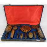 A 12 piece 1930s Chinese faux tortoiseshell vanity set in fitted velvet case, each piece decorated