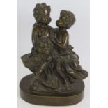 A small bronze figure of two young children sitting on a rock. Bearing signature Aug. Moreau (