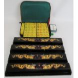 A vintage 1950s Chinese Mah Jong set with four hand decorated lacquer tile stands and zip up carry
