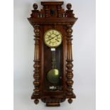 A late 19th/early 20th century Continental Vienna type striking wall clock in walnut glazed case.