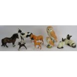 A collection of Beswick pottery animals including horses, owls and cats. Tallest 19cm. (9).