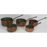 A set of five heavy copper saucepans with rivetted iron handles. Largest 20cm diameter. (5).