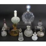 A collection of ten glass scent bottles, two with silver mounts, five cut glass and one signed.