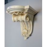 A 19th century carved wooden corbel bracket shelf with shell carved and scrolled decoration, painted