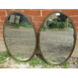A pair of 19th century French oval wall mirrors in bronze frames with cast tulip decoration to