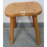 A light oak stool by Mouseman, on canted octagonal supports. Condition report: Some varnish loss