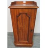 A Victorian walnut bedside cabinet, with ¾ gallery and panelled door, featuring brass campaign style