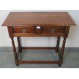 A reproduction cherry wood side table in an 18th century taste, with one long frieze drawer fitted