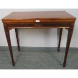 An Edwardian mahogany turnover card table, with carved frieze, on tapering square reeded supports