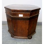 An 18th century oak octagonal cellarette with tin liner and handles to either side, on bun feet.