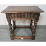 An 18th century oak joint stool in an early 17th century taste, with chisel carved frieze, on barley