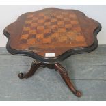 A Victorian mahogany tilt-top games table with rosewood and satin walnut chessboard inlay, on a