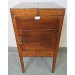 A Georgian oak gentleman’s shaving stand, the hinged double lid opening onto a fitted interior