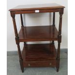 An early Victorian mahogany three tier whatnot, the top tier featuring an adjustable bookrest/