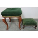 Two Victorian walnut footstools upholstered in green velvet, on cabriole supports with scrolled