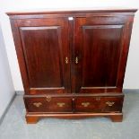 An 18th century mahogany linen press of small proportions, the double doors with inset fielded