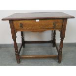 A vintage oak side table in the 18th century taste, with one long oak lined frieze drawer with brass