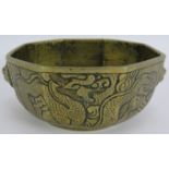 An antique Chinese bronze censer of octagonal form bearing chased dragon decoration. Later applied