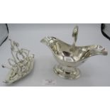 A silver plated double pourer pedestal sauce boat with acanthus leaf handle and an unusual silver