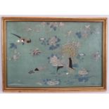 A framed Chinese silkwork panel depicting peacocks, birds and butterflies on a turquoise ground.