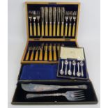 A boxed set of six Waring & Gillow teaspoons, a boxed set of fish knives and forks with hallmarked