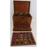 An antique lotto type ball game consisting of box, numbered board and wooden balls. 27cm x 21cm x