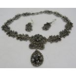 A 1950's white metal style necklace with joined up links of sprays of flowers set with many stones