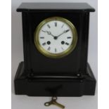 A Victorian black slate striking mantel clock with French Japy Freres. Pendulum and key present.