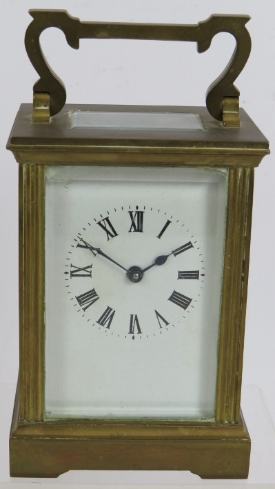 A brass cased 8 day carriage clock with white enamel dial. Key present. Height 15cm. Condition