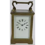 A brass cased 8 day carriage clock with white enamel dial. Key present. Height 15cm. Condition