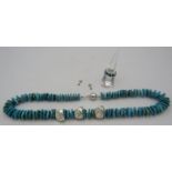 An American Navaho Indian turquoise coloured necklace with 3 white metal triangular beads and