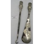 A silver handled button hook and matching shoe horn. Birmingham 1912. Condition report: Marks on